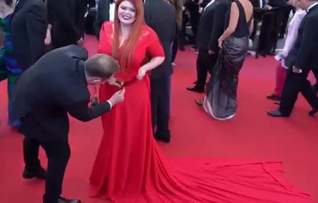 Plus-size model is left standing in her UNDERWEAR on Cannes red carpet after a passerby steps on her dress - but she's accused of 'faking it for fame' 