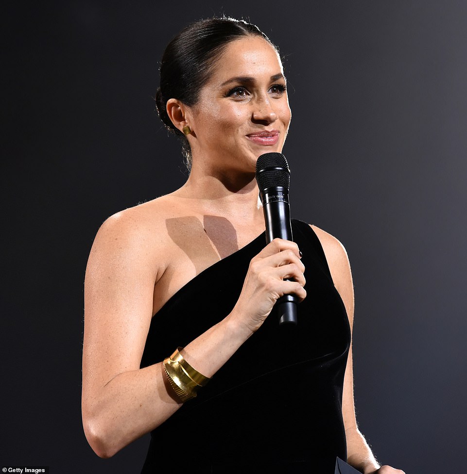 Duchess of Sussex STUNS onlookers in surprise appearance to honour wedding dress designer at Fashion Awards